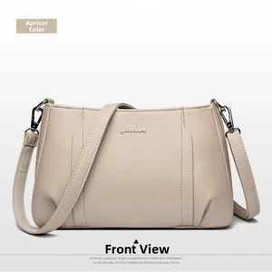Front view of apricot cross-body bag featuring lychee grain leather and silver metal logo