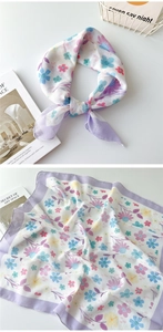 Detail eines geblümten Leinenschals mit Macaron-Blumenmuster und feinen Nähten