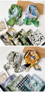 Detail of assorted lightweight scarves with floral and landscape artistic prints