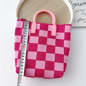 Pink checkered knit bucket bag with handle and tape measure showing 20cm height