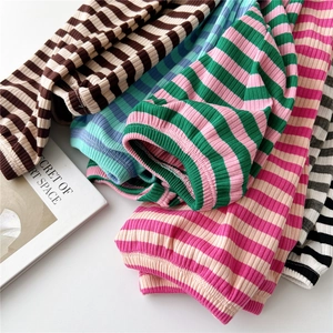 Close-up of colorful striped ribbed knit sleeves with soft texture and rolled edges