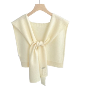Creamy white 100% wool knitted shawl displayed on a wooden hanger for a minimalist look