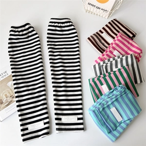 Striped knit arm sleeves for women in various colors shown in a flat lay arrangement