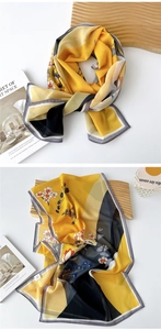 Detailed view of lightweight yellow silk scarf with elegant plum blossom floral print