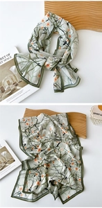 Detail of light green floral sheer scarf with fine edge stitching and leaf prints