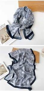 Detail of semi-transparent grey-blue chiffon scarf with dark blue rose floral patterns
