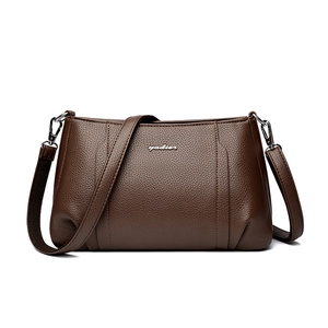 Elegant dark brown pebble leather crossbody bag for women with silver metal logo and strap