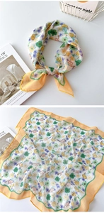 Detail eines geblümten Baumwoll-Leinen-Halstuchs mit gelbem Rand und luftiger Textur