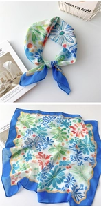 Detailansicht eines Baumwoll-Leinen-Halstuchs mit blauen und orangen Blumenmustern
