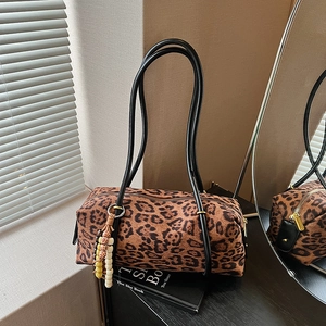 Retro leopard print cylinder handbag with black leather handles and beaded charm detail
