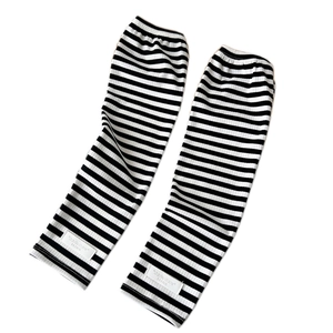Classic black and white striped knit arm warmers with minimalist brand logo tag