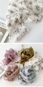 Detailed close-up of pleated floral triangular scarves in five elegant pastel colors