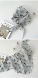 Detail of light blue floral chiffon scarf showing delicate rolled edges and sheer texture