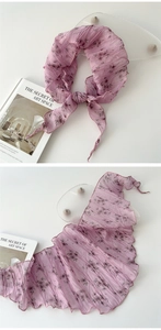 Close-up of pleated lavender floral chiffon scarf featuring delicate rolled edges