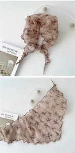 Detailed view of pink floral pleated chiffon scarf with delicate wavy hem and soft texture