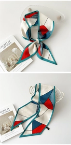 Détail d'un foulard en soie géométrique noué en nœud sur un plateau en verre chic