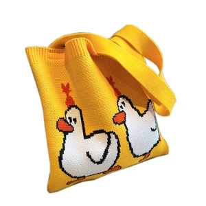 Vibrant yellow knitted tote bag with cute cartoon white ducks and red hat pattern