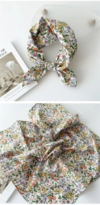Détail macro d'un foulard en lin à fleurs avec de petites marguerites blanches et motifs