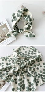 Vue détaillée du foulard carré en coton et lin avec petits motifs de marguerites vertes sur blanc