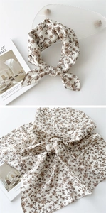 Vue détaillée d'une écharpe en coton et lin beige avec imprimé floral marron doux