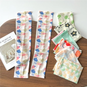 Detail showing various ice silk sun sleeves with colorful prints on a wooden table