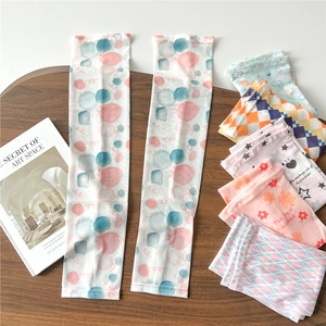 Detail of breathable cooling arm sleeves featuring pink and blue polka dot patterns