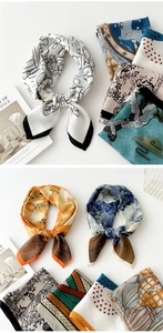 Detail of silk-like cotton scarves with artistic prints and vibrant colors on white background