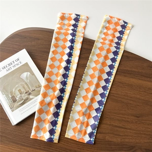 Detailed view of checkered sun protection sleeves in orange and purple ice silk fabric