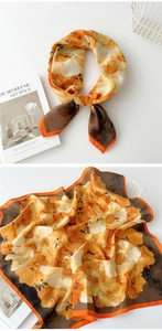 Detail of artistic floral cotton-linen square scarf with warm orange and yellow patterns