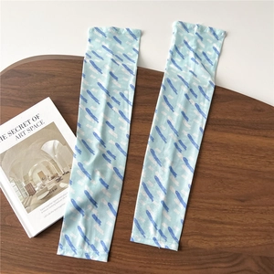 Detail of light blue ice silk sun protection sleeves with striped pattern on wood