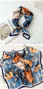 Detail of oil painting style silk scarf with abstract blue and orange print patterns