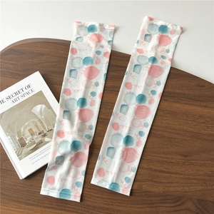 Close-up of lightweight cooling sun sleeves with watercolor polka dot print on fabric