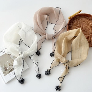 Linen cotton triangle scarves with tassels in white, pink, and beige minimalist tones