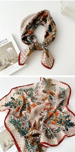 Detail of vintage square scarf with bird and floral prints on elegant silk texture
