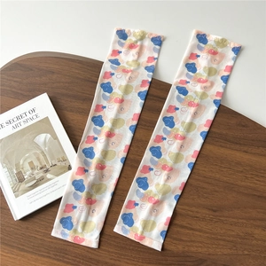 Detailed view of colorful abstract sun protection sleeves on a wooden tray background