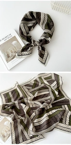 Detail of geometric weave print silk scarf in brown and olive with black borders