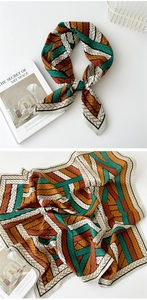 Close-up of geometric pattern silk scarf with orange and green vintage weaving texture