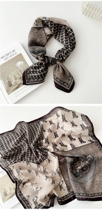 Detailed view of silk-like square scarf with retro animal and geometric prints
