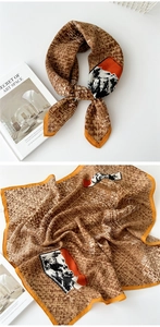 Detail of cotton linen scarf with geometric weave patterns and orange borders