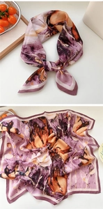Detail of square scarf featuring an abstract purple butterfly pattern and soft texture