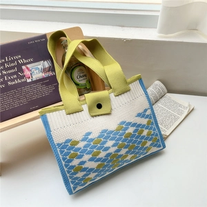 Knitted tote bag with blue and green rhombus pattern featuring wide shoulder straps