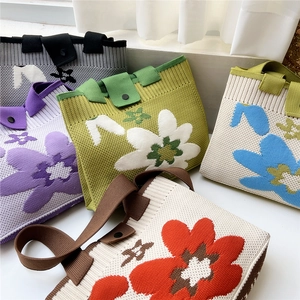 Floral knit tote bag set in purple and green showing large flower pattern and texture