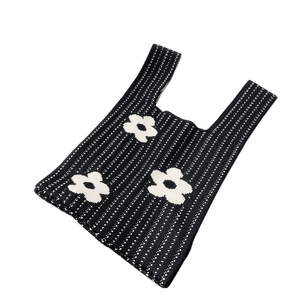 Minimalist knit tote bag featuring white daisy flowers on black vertical stripes