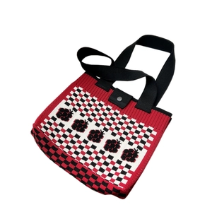 Knitted tote bag featuring a red and white checkered pattern with floral jacquard details