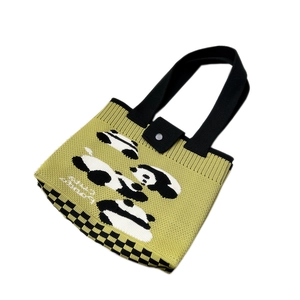 Green knitted panda tote bag with checkerboard pattern and secure buckle closure