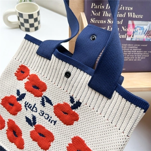 Floral knit tote bag with nice day lettering and durable navy blue handles