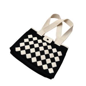 Minimalist knit tote bag featuring black and white diamond pattern and wide cream straps