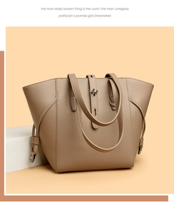 Close-up of beige lychee texture leather tote bag with elegant metal buckle detail
