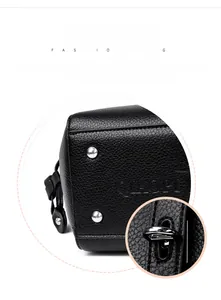 Detail view of black litchi pattern leather tote with metal studs and twist lock