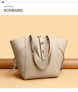 Close-up of beige lychee texture leather tote with adjustable side drawstring and silver lock